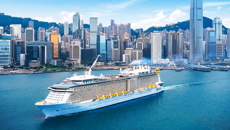 Royal Caribbean cruise ship sailing past the Singapore skyline